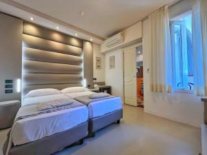 Łóżko lub łóżka w pokoju w obiekcie Hotel Regina