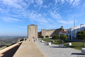 a building with a clock tower on a hill at AL-Andalus in Elvas