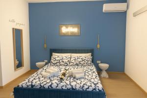 a blue bedroom with a bed with a blue wall at Lodevì in Foggia