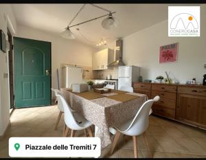 a kitchen with a table and chairs and a green door at Conero Casa - Marcelli di Numana in Piazzale Tremiti 7 con Parcheggio Esclusivo in Marcelli +32 photos