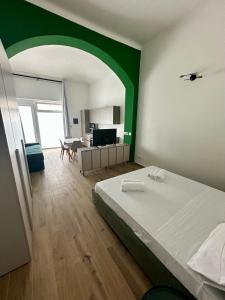 a bedroom with a bed and a green wall at Casa San Clemente - Porta Susa FS in Turin +1 photo