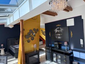 a living room with a fireplace and a chandelier at Starlight in Hamburg