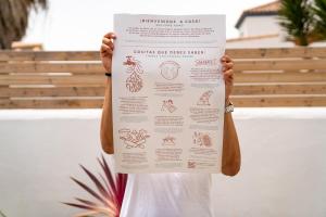 a person holding up a poster with their hands at Los jardines de Zahora C02 in Cádiz