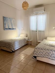 Postel nebo postele na pokoji v ubytování Nefeli Beach Home