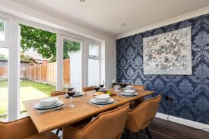 a dining room with a wooden table and chairs at Hazel House Spacious 3BR Home Parking WiFi Contractor Friendly in Ifield