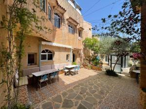 a courtyard of a building with a table and chairs at DAR Dunia Panoramic terrace in Chefchaouen