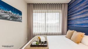 a bedroom with a large window and a large bed at Passos Manuel by Innapartments in Porto