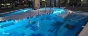 a swimming pool with a ball in the water at Holiday Beach Budapest Wellness Hotel with Sauna Park in Budapest