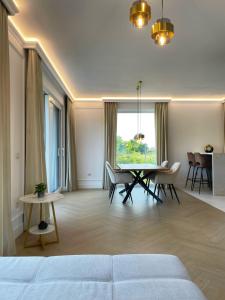 a living room with a couch and a table at Emerald Home in Suceava