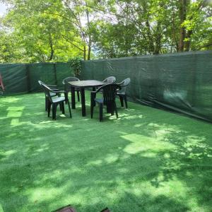 a patio with tables and chairs and a fence at Tampa Holiday Vila in Braşov