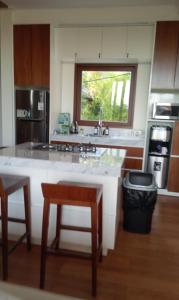 a kitchen with a counter and a window in it at Avela bali villa in Kerobokan +8 photos