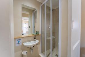 a bathroom with a sink and a shower at 9 Quarter Deck in St Francis Bay +16 photos