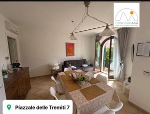 a living room with a table and a couch at Conero Casa - Marcelli di Numana in Piazzale Tremiti 7 con Parcheggio Esclusivo in Marcelli