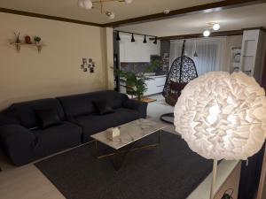a living room with a blue couch and a table at Shim Gwangan in Busan