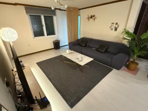 a living room with a couch and a table at Shim Gwangan in Busan