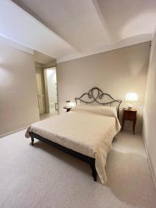 a bedroom with a bed and two tables and two lamps at Casa Edvige Suite in Monteveglio