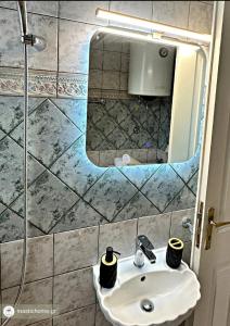 a bathroom with a sink and a mirror at Komi Serenity Home in Chios +6 photos