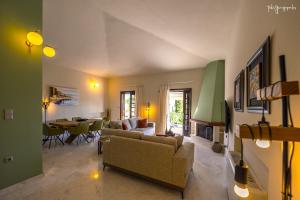 a living room with a couch and a table at Apartment inside Villa Daniela-Elegant & Luxury Style-Private Pool in Schinias