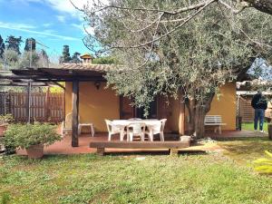 a patio with a table and chairs in a yard at Casa Fiordaliso in Ansedónia