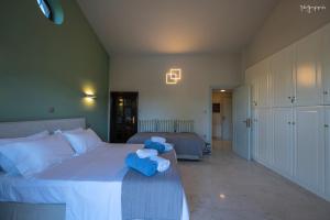 a bedroom with a bed with two blue teddy bears on it at Apartment inside Villa Daniela-Elegant & Luxury Style-Private Pool in Schinias +45 photos
