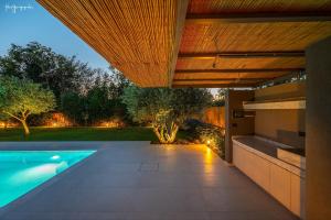 an external view of a house with a swimming pool at Apartment inside Villa Daniela-Elegant & Luxury Style-Private Pool in Schinias