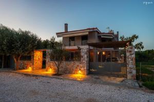 a house with lights in front of it at Apartment inside Villa Daniela-Elegant & Luxury Style-Private Pool in Schinias