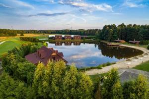 an aerial view of a house and a lake at Cyziówka in Kamionka