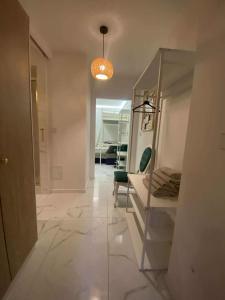 a hallway with a table and a chair in a room at Solne Apartamenty Luna 4 in Wieliczka