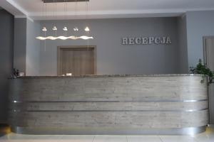 a restaurant with a wooden counter in a room at Neptun in Kołobrzeg