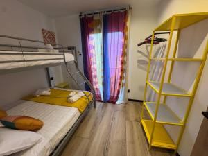 a bedroom with a bunk bed and a yellow shelf at Casa Faixa - Refugio en las Rías Baixas in Cangas de Morrazo +20 photos