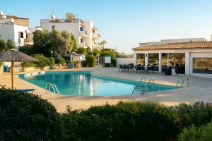 ein Swimmingpool mitten in einem Gebäude in der Unterkunft HiddenGems Residences 202 - The LXR Penthouse - Pool & Beach Steps in Paphos City