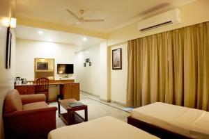 a hotel room with a bed and a desk at hotel sandhu palace in Jodhpur +5 photos