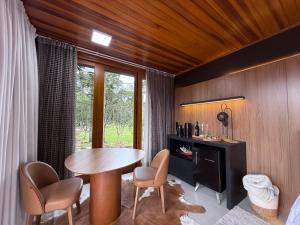 a room with a table and chairs and a window at Pousada Maçã Araucária in São Joaquim