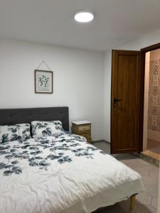 a bedroom with a bed and a wooden door at Garden House in Budva