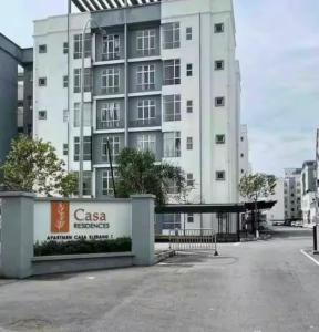 a large white building with a sign in front of it at DQis Nest Casa Apartment in Chemor