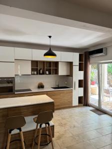 a kitchen with a counter and two stools at Garden House in Budva