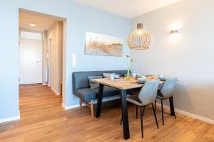 a dining room with a table and chairs at Haus Uthlande HAus Uthlande Whg 46 Watten Blick in Wyk auf Föhr +14 photos