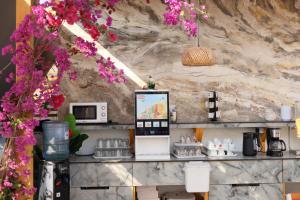 a room with a counter with flowers on the wall at Ilio Boutique Hotel in Ksamil