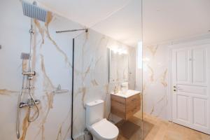 a bathroom with a toilet and a sink and a shower at Villa Golden Tiara Large Private Pool AC WiFi in Corfu +19 photos