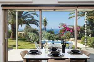 a dining table with a view of the ocean at Villa Sevos in Loutra