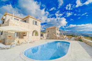 a villa with a swimming pool in front of a building at Villa Dioni Thio in Pírgos