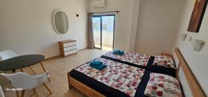 Un dormitorio con una cama y una mesa y una mesa y una silla. en Pergamonto Apartments, en Ayia Napa