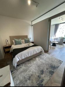 a large bedroom with two beds and a rug at Dante One Rosebank Apartment in Johannesburg