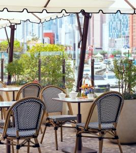 a table and chairs with a view of a city at Grand Josun Busan in Busan