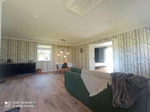 a living room with a couch and a table at Agroturystyka Renatka 