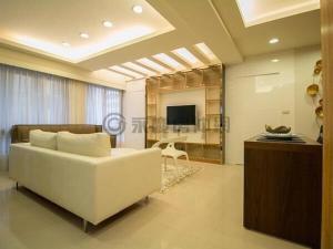 a living room with a white couch and a television at Taipei City Tianmu near Zhishan MRT Station in Taipei +10 photos