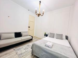 a bedroom with two beds and a couch at High standard rooms Central Lisbon, super for tourists in Lisbon