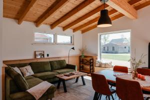 a living room with a couch and a table at Ahoi Village Fehmarn in Fehmarn