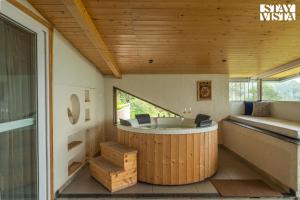 a large tub in a room with a window at StayVista at The Ever House with Bonfire, Jacuzzi, Bathtub in Dharampur +149 photos