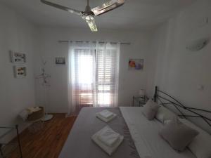 a bedroom with a bed and a ceiling fan at Villa Sandra Hvar in Hvar